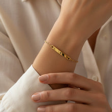 Charger l'image dans la galerie, Bracelet de vœu Fleur Nabert créations en acier doré avec une étoile gravée, porté au poignet par une femme
